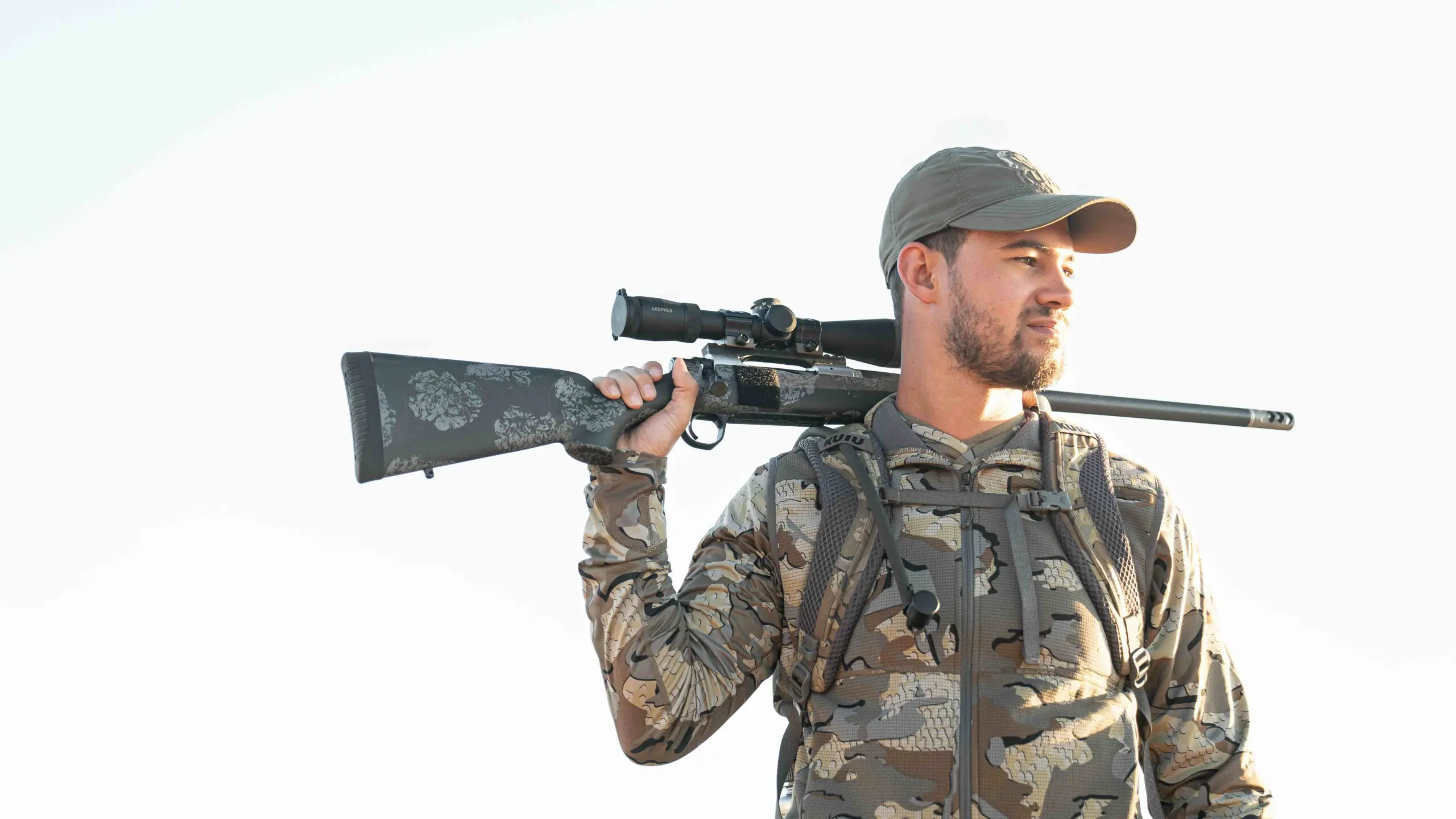 Hunter carrying a Christensen Arms rifle with a carbon fiber stock