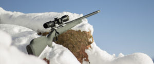 Christensen Arms Classic Rifle with Scope in snow