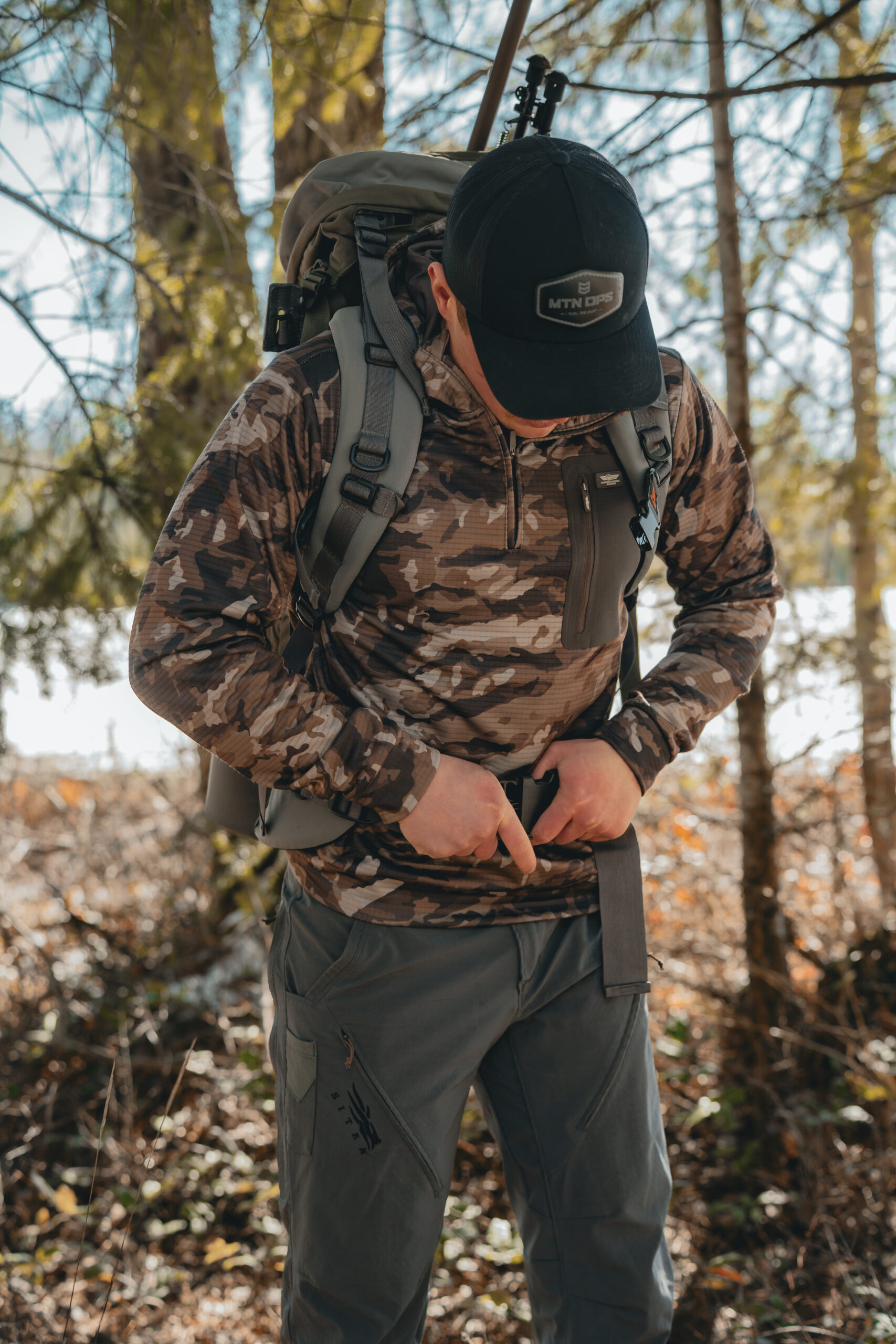Backcountry hunter using a mountain hunt layering system