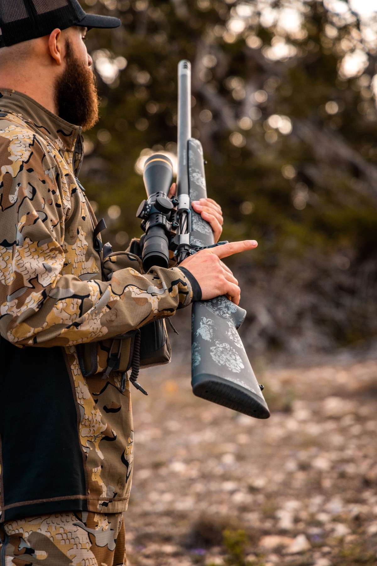 Hunter carrying a Christensen Arms rifle with a stainless steel barrel