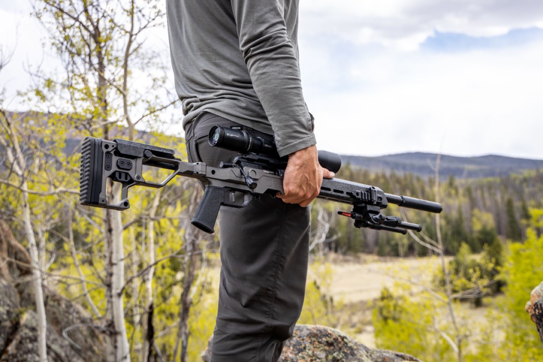 Shooter carrying a Christensen Arms rifle with a carbon fiber barrel