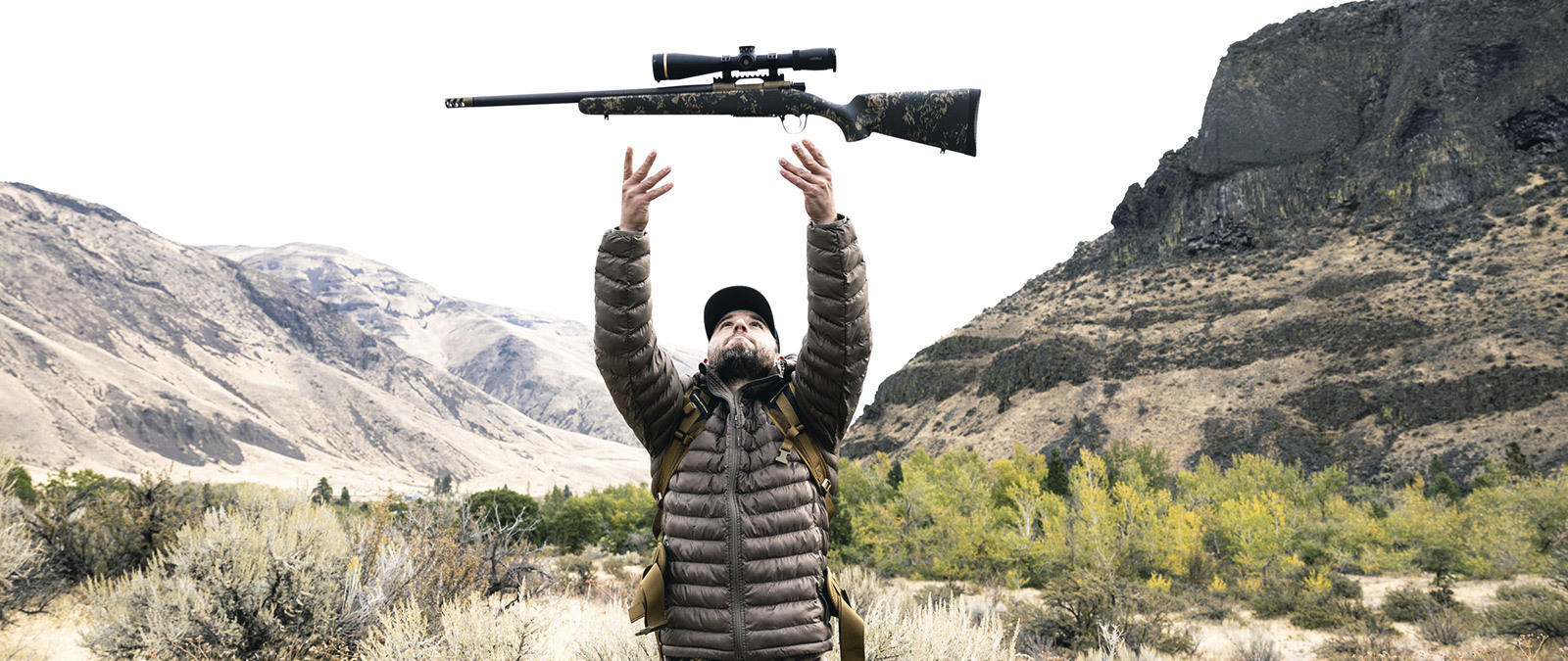 Hunter demonstrating the low weight of a mountain rifle