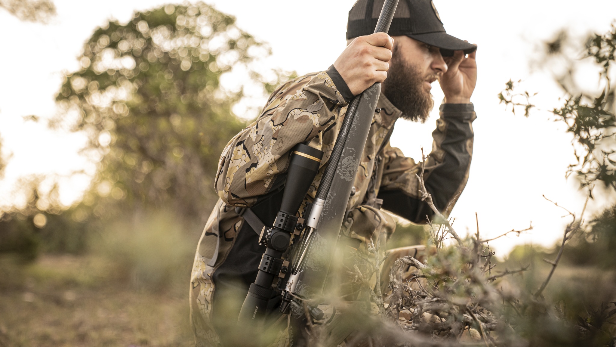 Hunter carrying a lightweight hunting rifle through brush